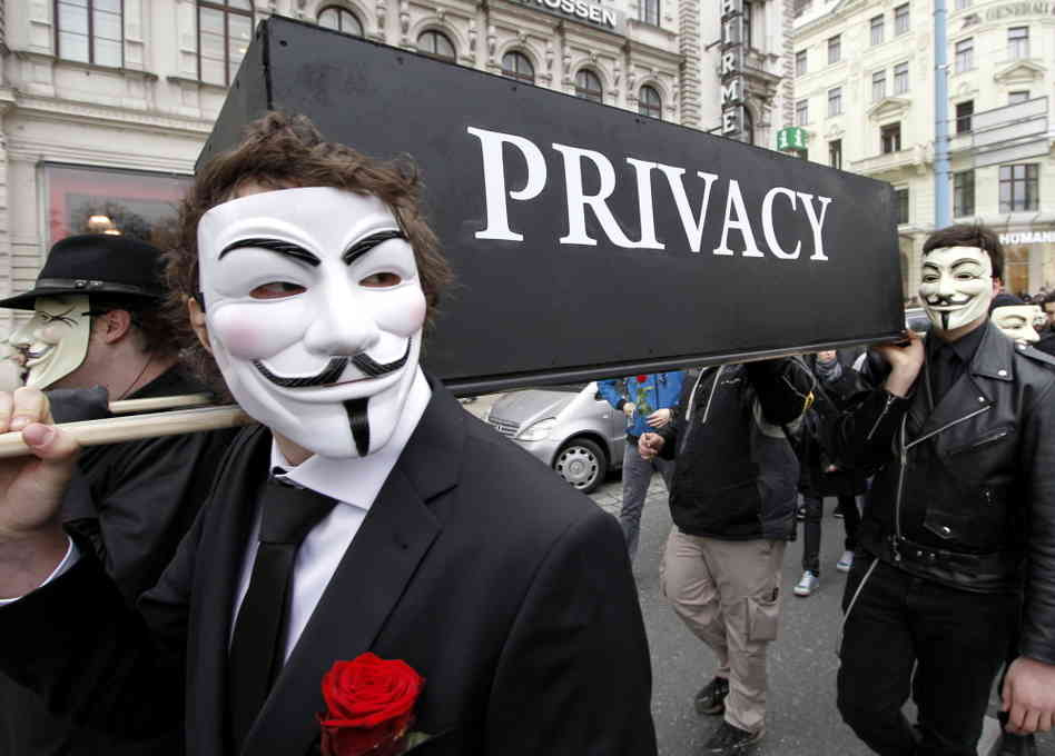 Anonymous activists holding a coffin named privacy